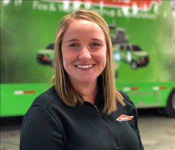 woman in front of a SERVPRO trailer