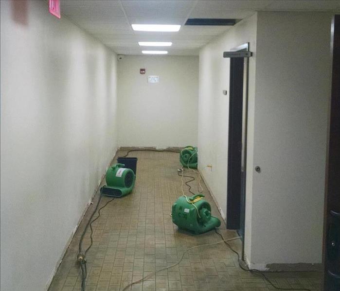 a hallway being dried out with air movers from a water damage